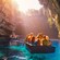 2 boats filled with Guests explore Melissani Caves as sunlight pours in from high above